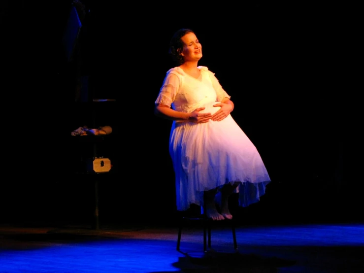 an old woman standing on a stool in front of blue light