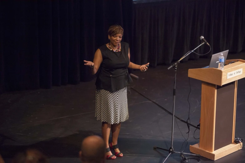 a person standing in front of a podium with a laptop