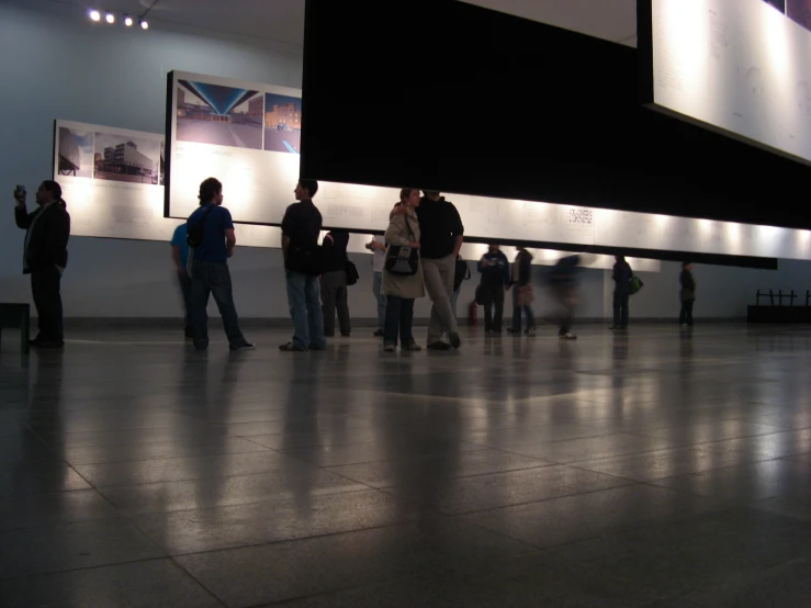 a group of people stand around in a museum