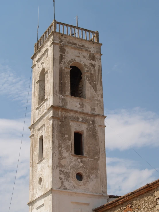 the tower of an old church, with an iron handrail