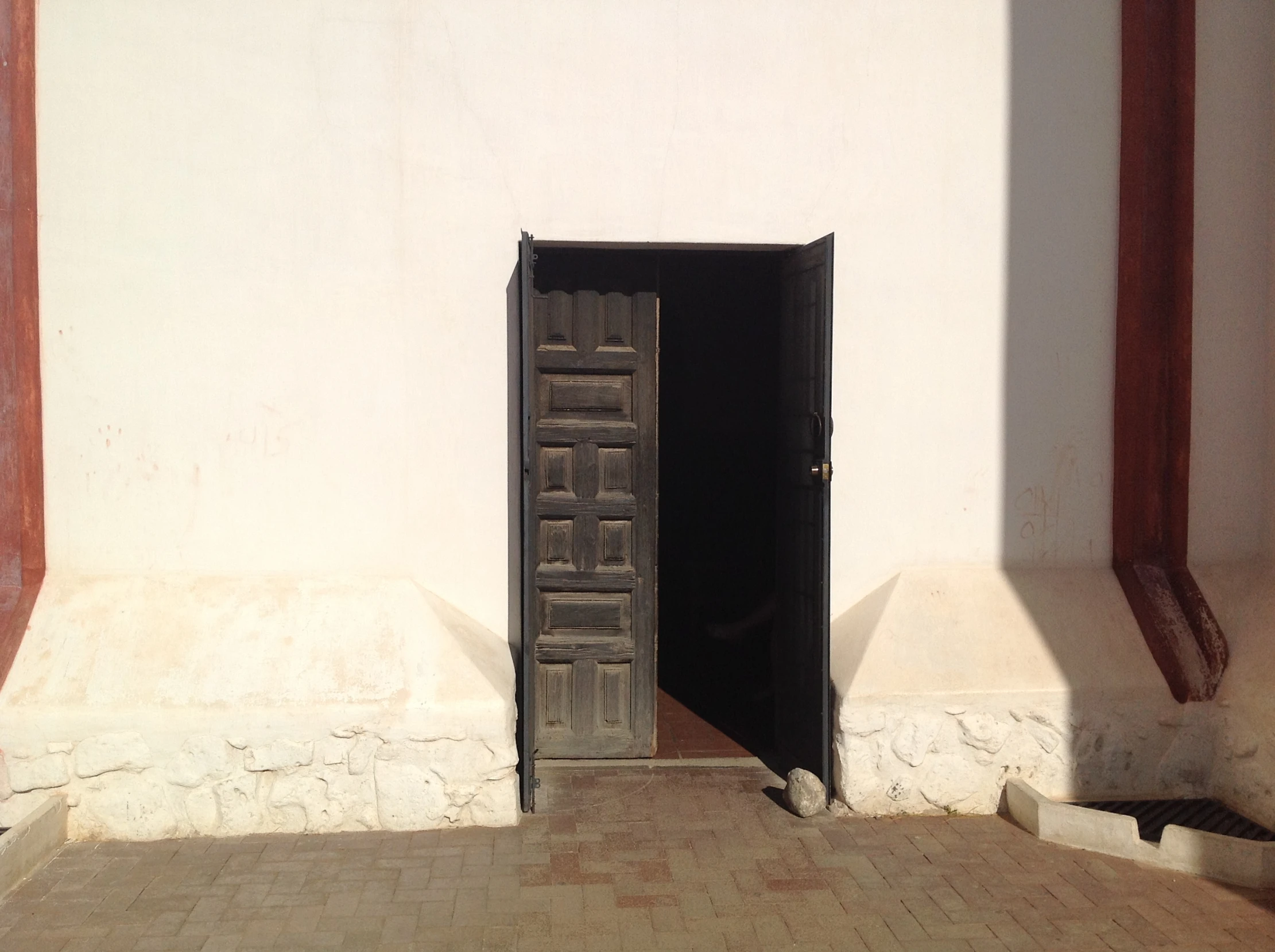 a doorway with a brick path going into it