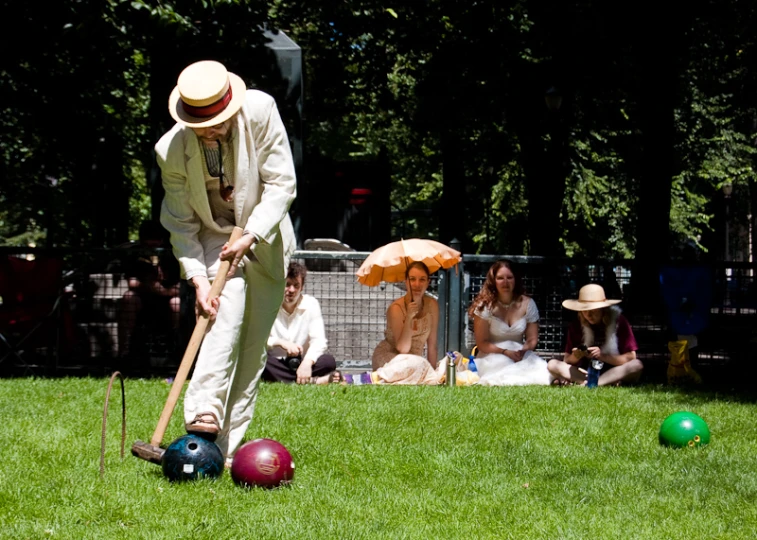 a man is leaning over to catch the ball