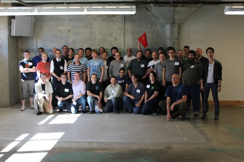 an outdoor group po of people standing in a room