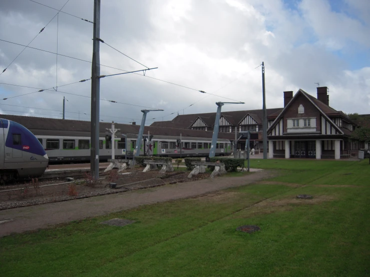 a train passing by several houses and power lines