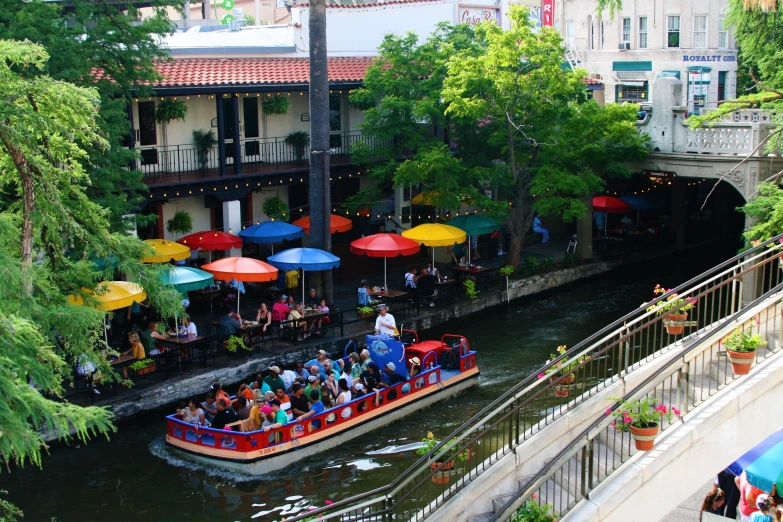 a boat is filled with people and umbrellas