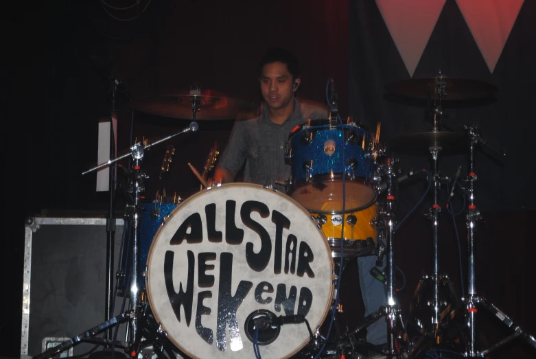 a man is playing a song on a drum set