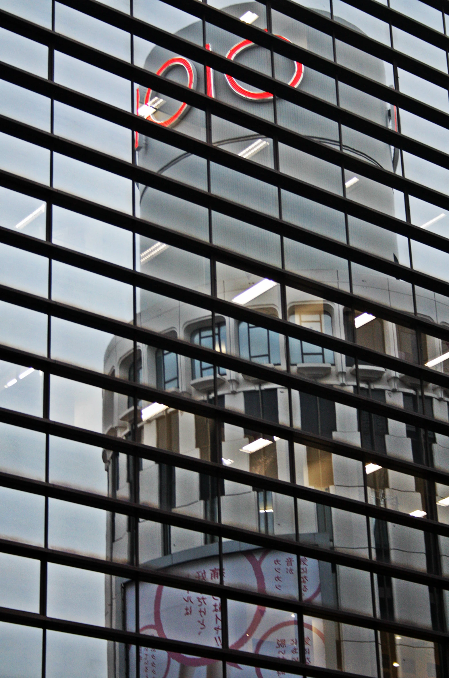 a red and white building reflected in the front window of the building