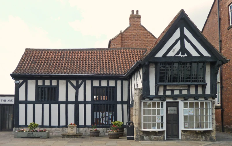 two buildings are built with windows and brown roofing