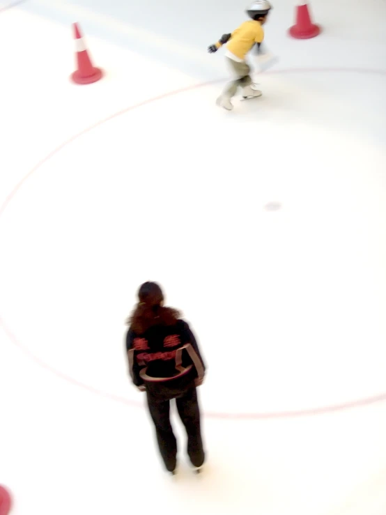 a person with a backpack in front of a group of orange and red cones