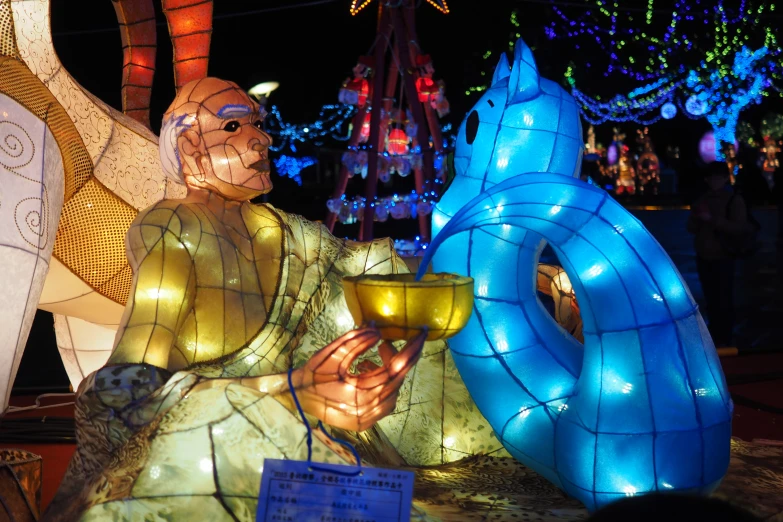 some colorful floats and people are standing around