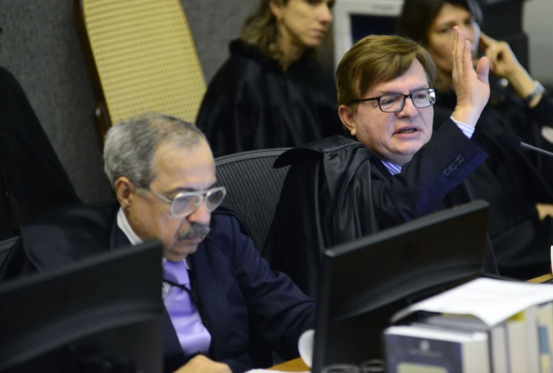 a judge sitting in front of his laptop during a law debate