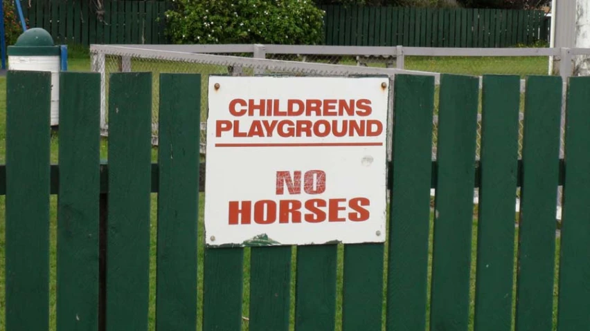 a sign on a fence warning of children playing