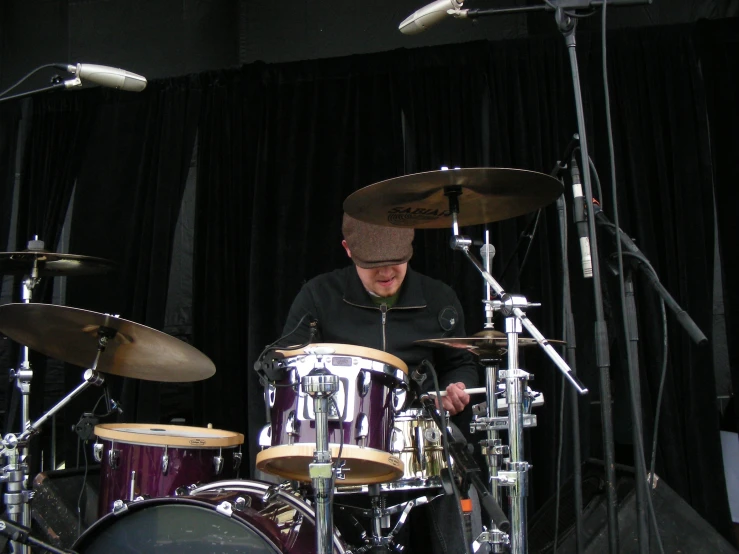 a man is playing the drums and is on stage