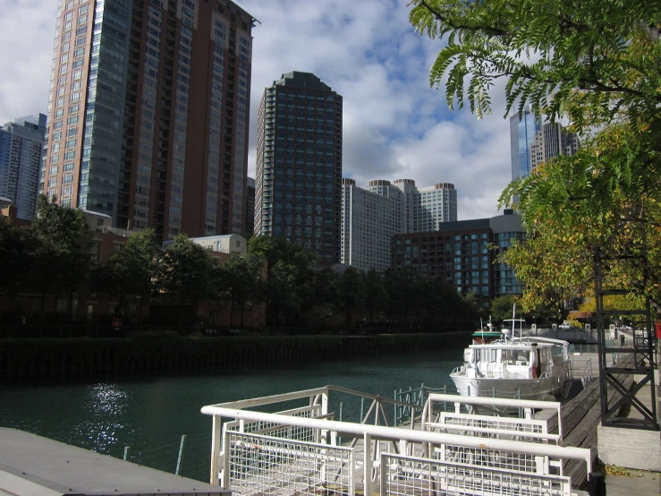 the boats are docked on the waterway in front of a large city