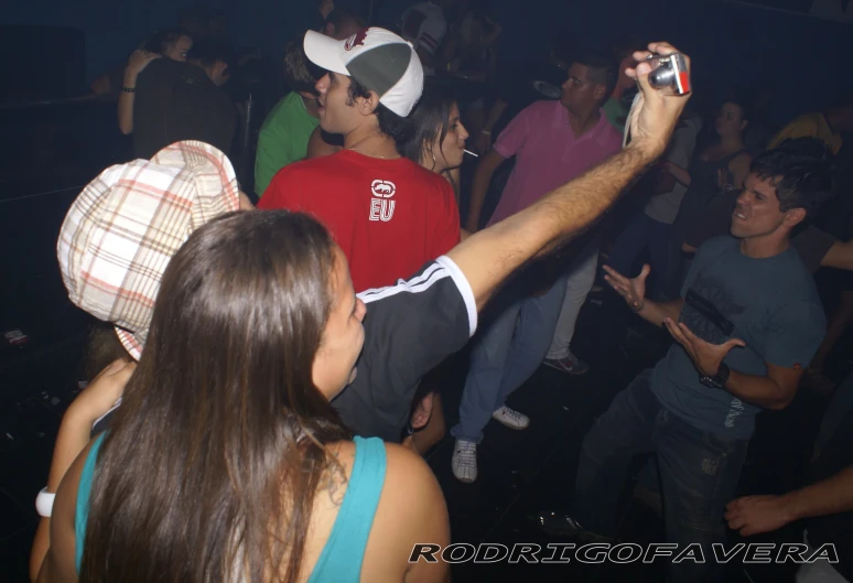 the group is dancing on the dance floor at a party