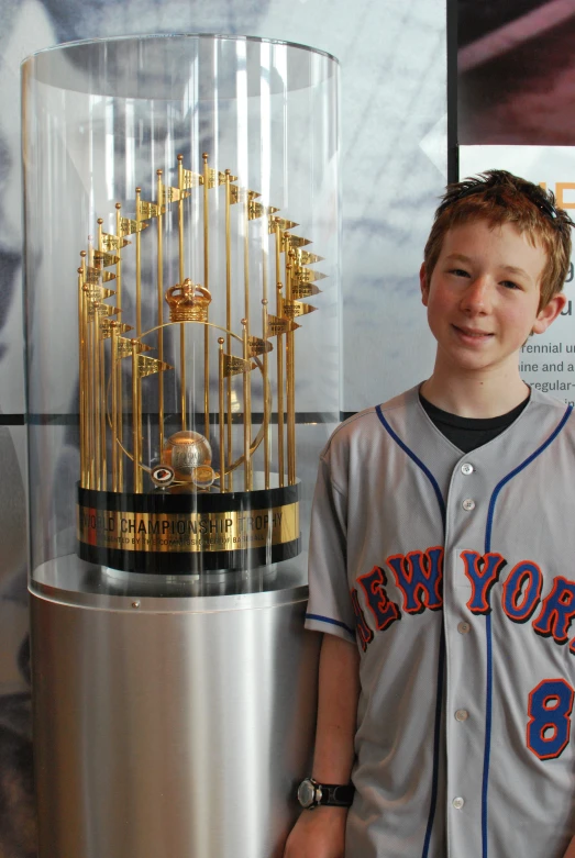 the  is posing beside the trophy