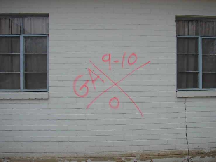 a white brick wall with graffiti on it