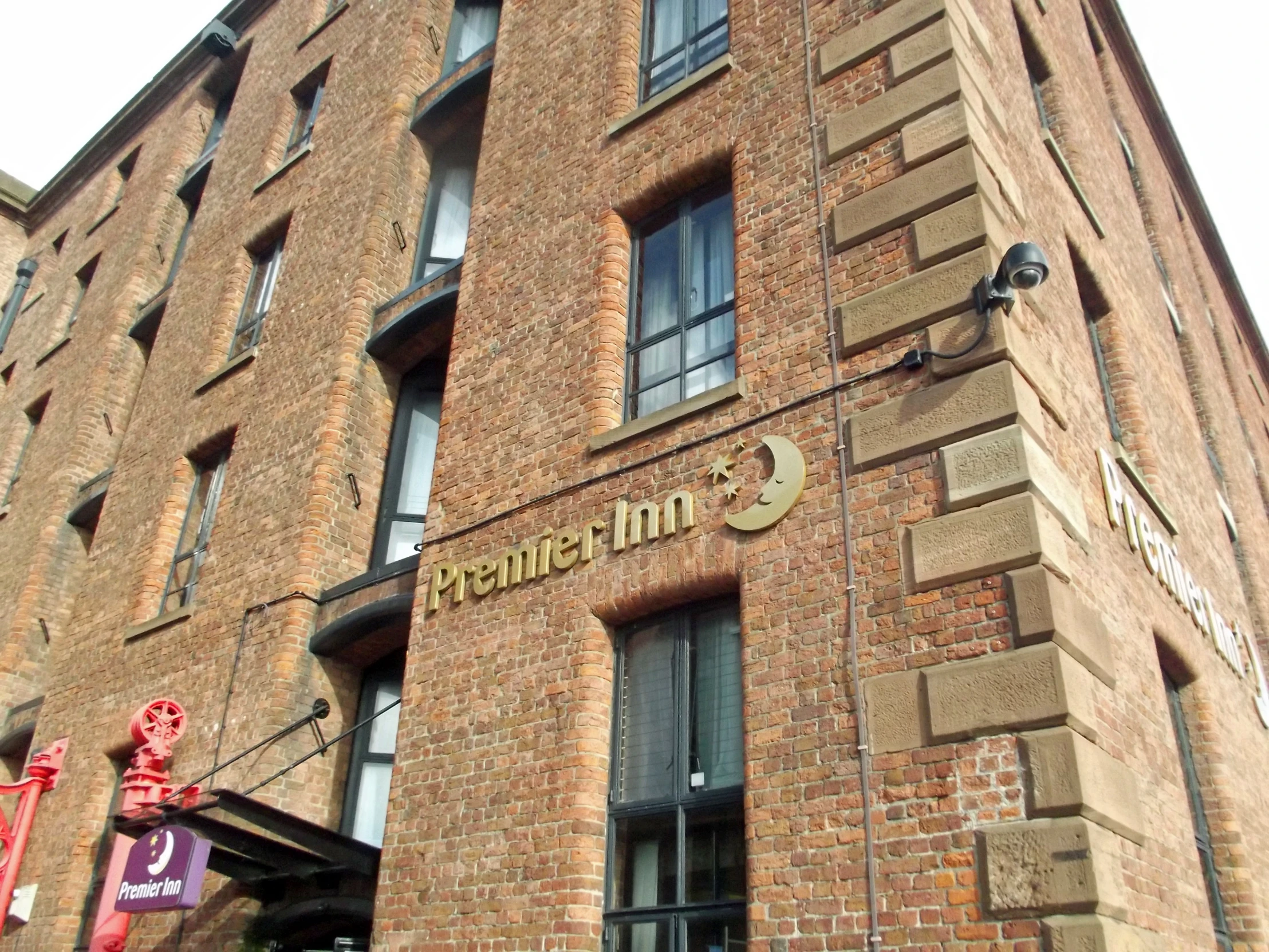 the front of a brick building has windows