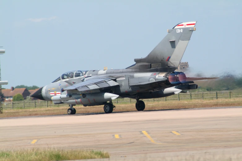 fighter jets are on the landing strip at an airport