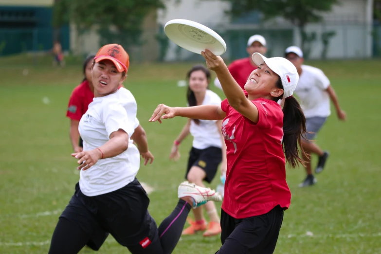 several women are playing frisbee on the field