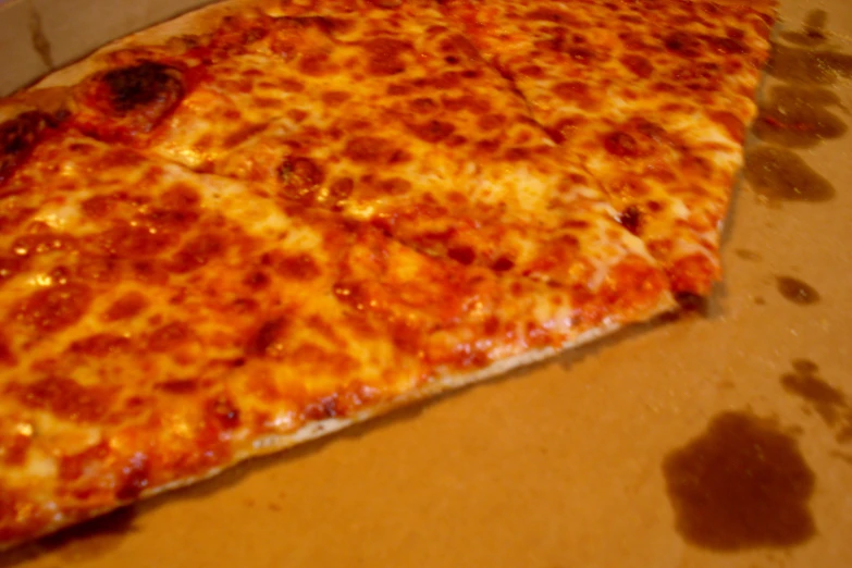 a large pepperoni pizza cut into smaller pieces