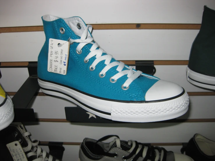 converse blue shoes with tag attached to the bottom