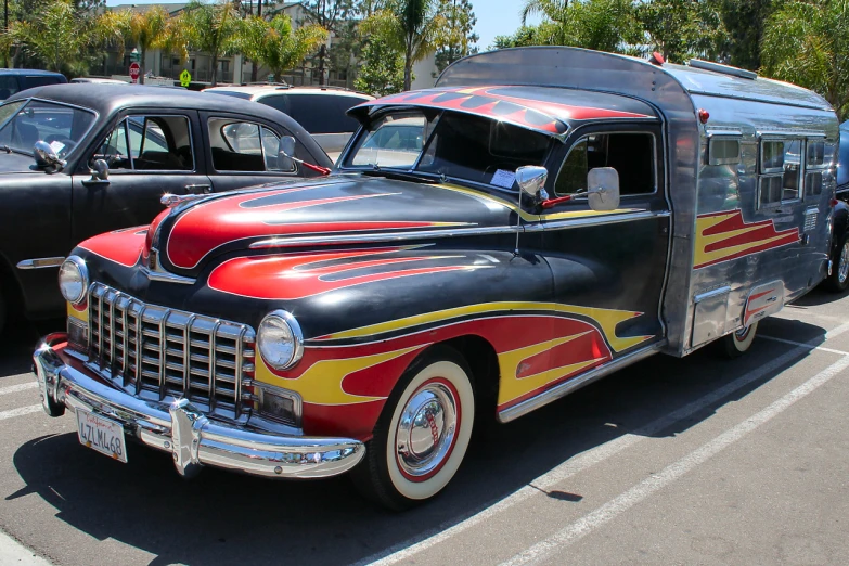 an old firetruck parked next to others in a parking lot