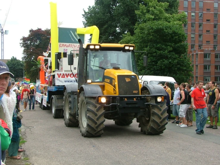 the people are watching the tractor and parade float