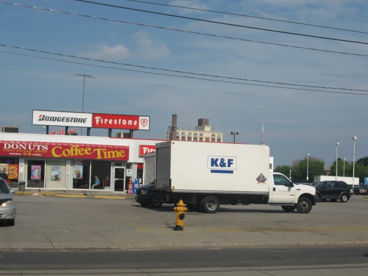 a truck in front of a k & e store with the door open