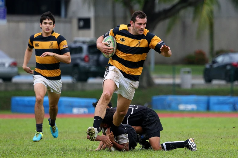 a rugby player is jumping to take the ball