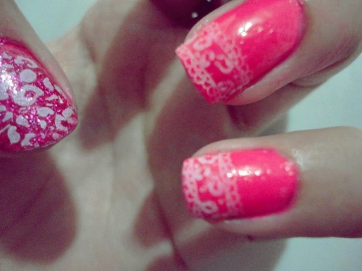 a girl's pink manicure with an ornamental design