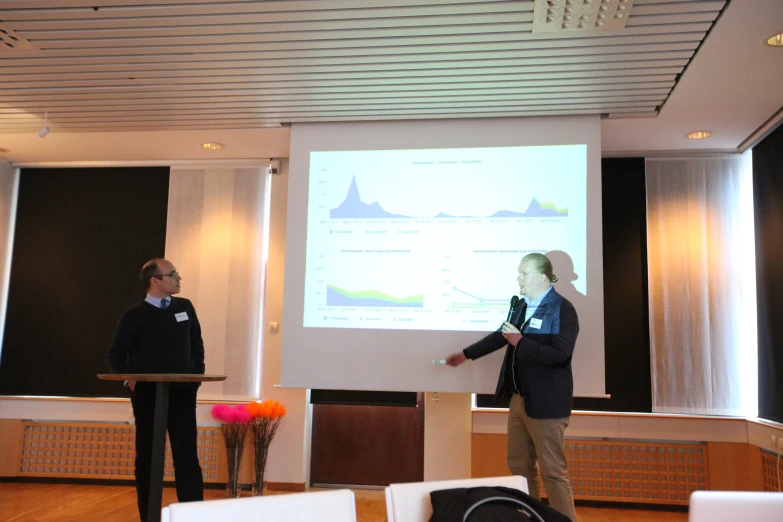 a guy presenting a presentation with another boy standing by