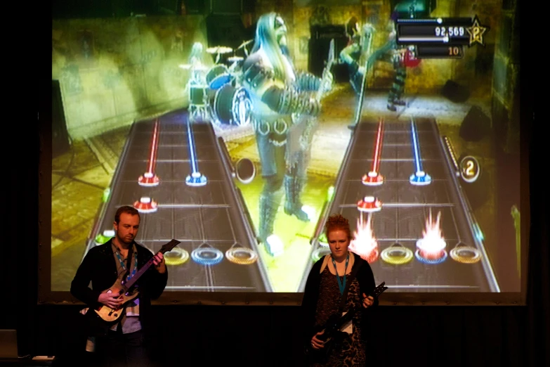 two people are playing wii video games on a big screen