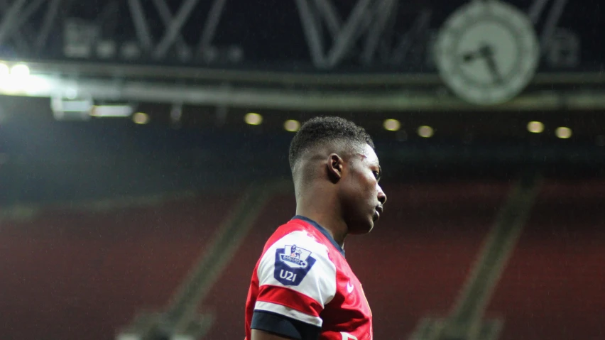 a man stares at the corner of an empty stadium