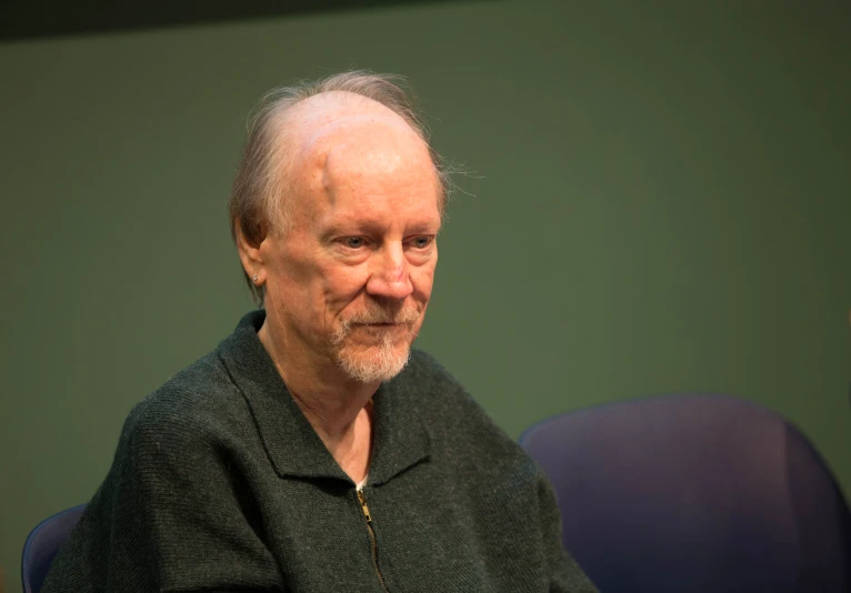 a man with a white beard wearing a black shirt