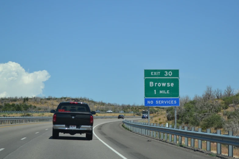 a car going down a highway past a freeway sign