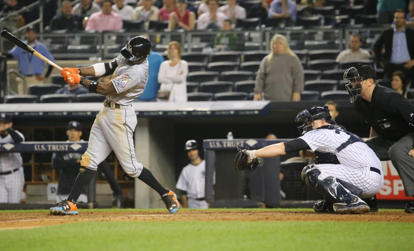 some baseball players are playing baseball on a field