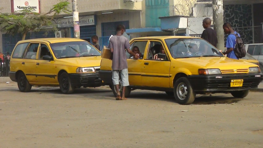 the men are looking at the cars in the city