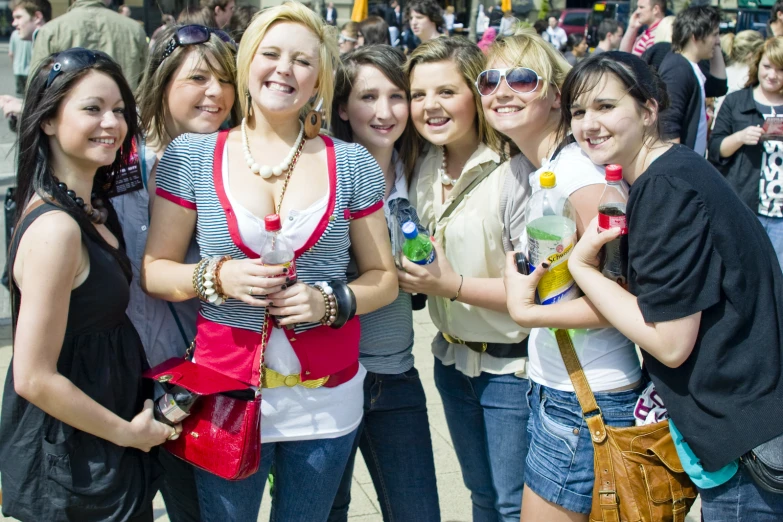 group of girls posing for po with people in background