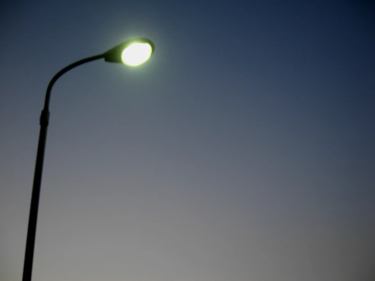 a street lamp that is lit at night