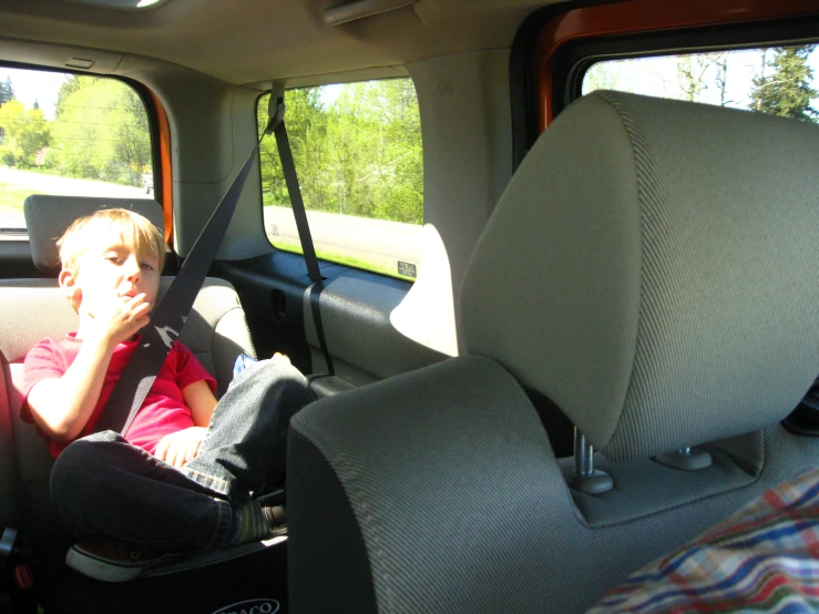 a  sitting in the backseat of a pickup truck