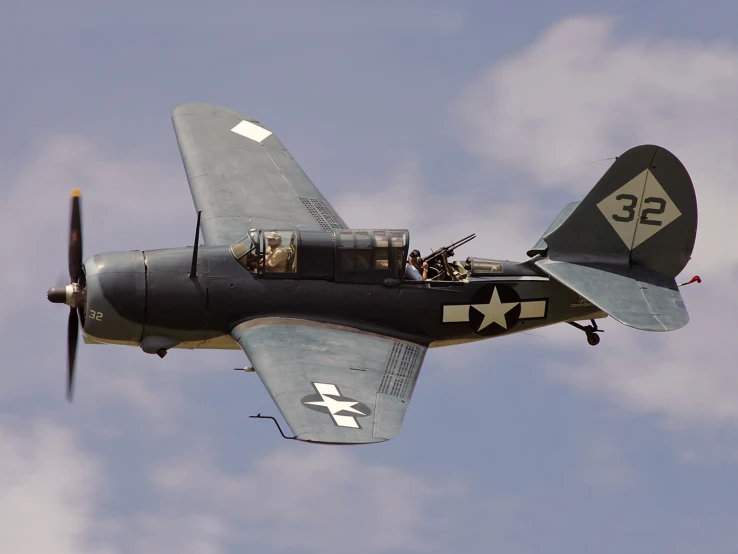 a black war plane flying through the sky