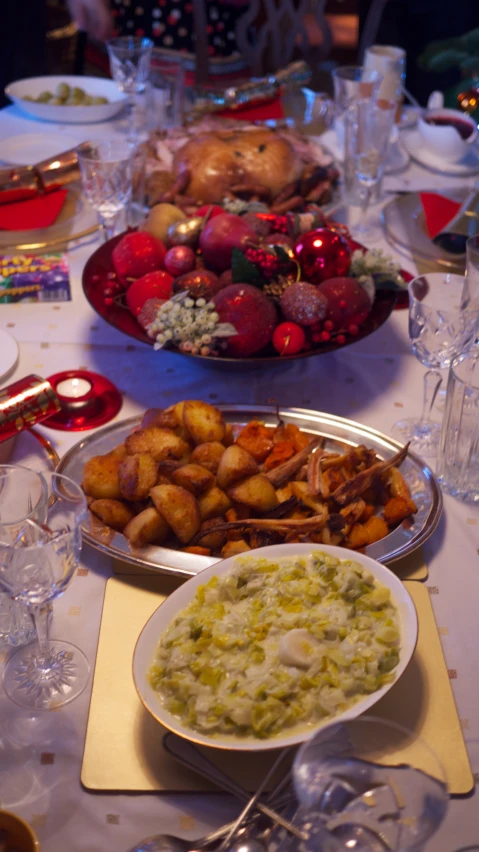 a table with bowls of food and place settings