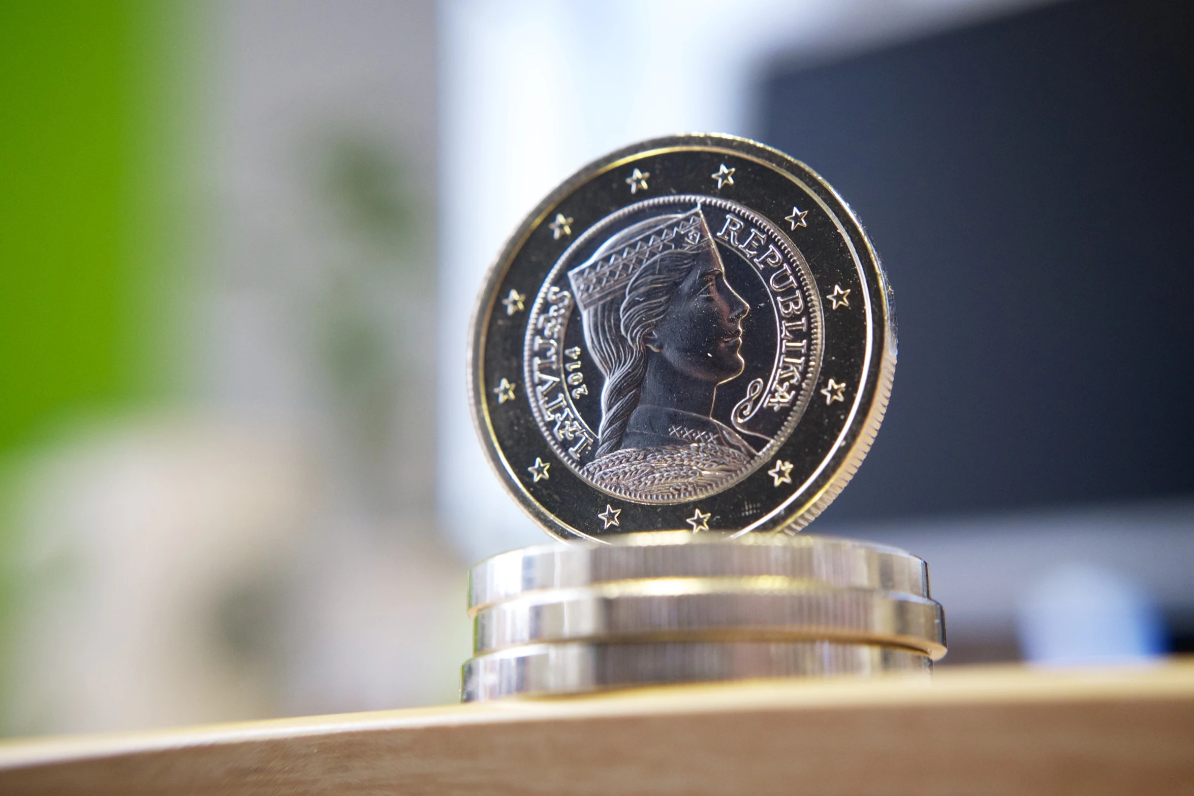 coin on stack of coins with blurry background