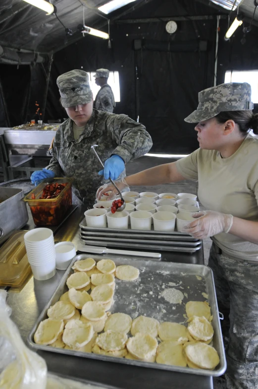 several military people working together making treats