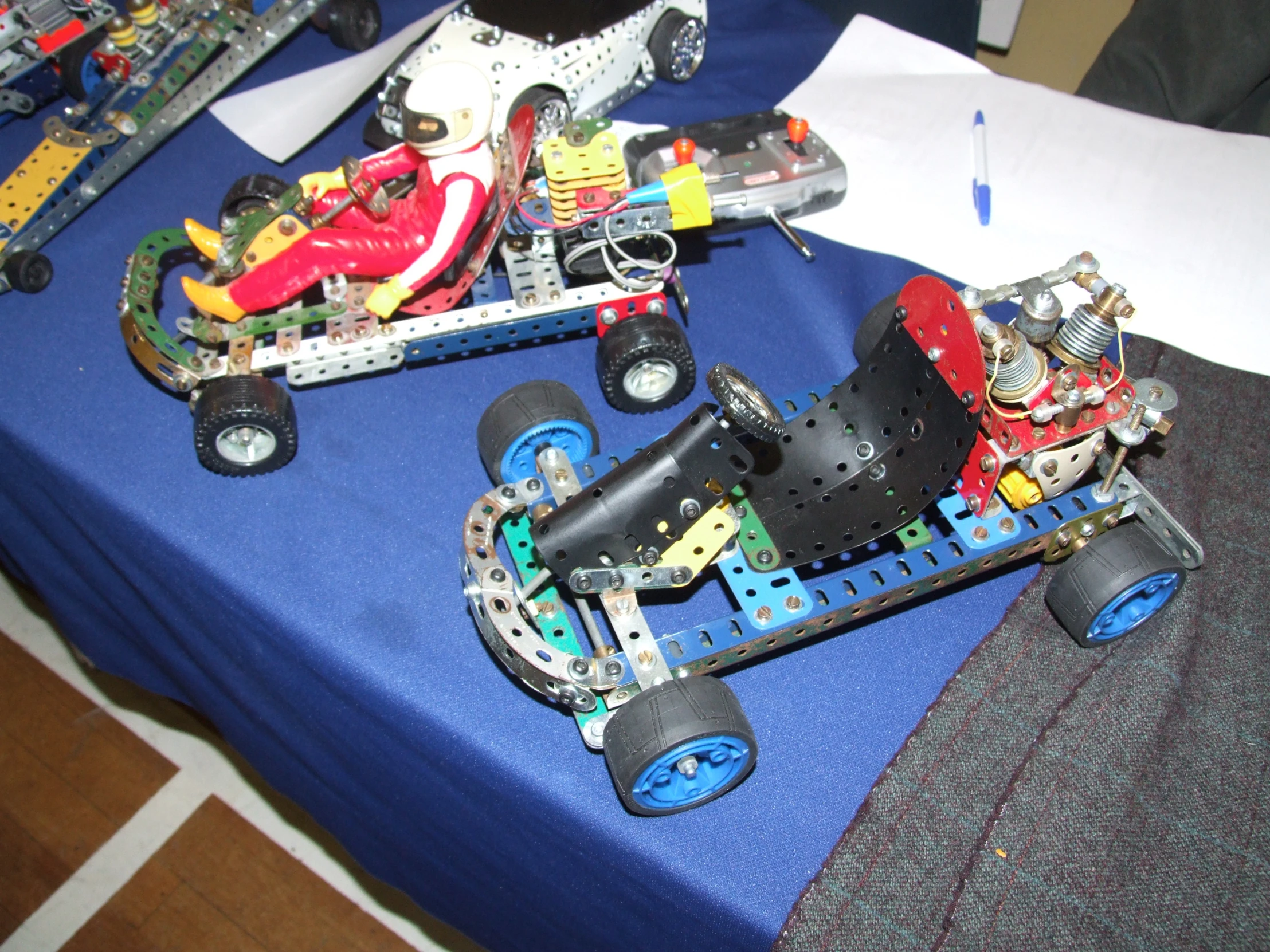 several small toy race cars are shown on a table