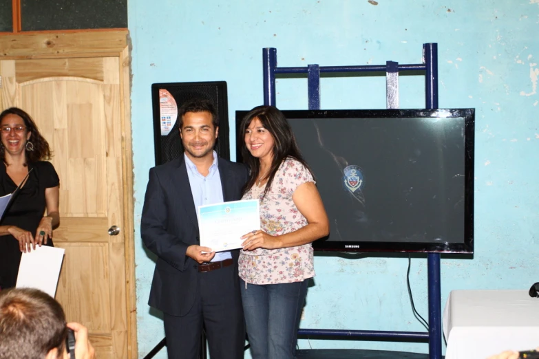 a man is presenting a paper to the woman in the room