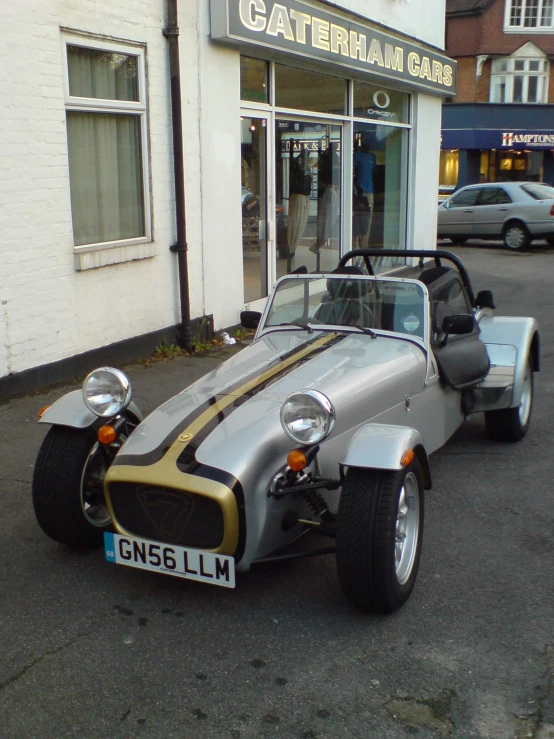 an old car sits parked in front of the building