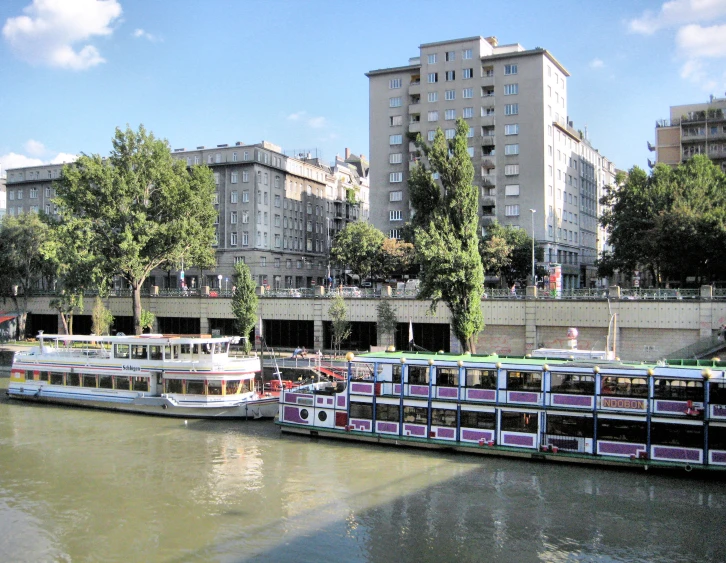 there is a large passenger boat parked in the water