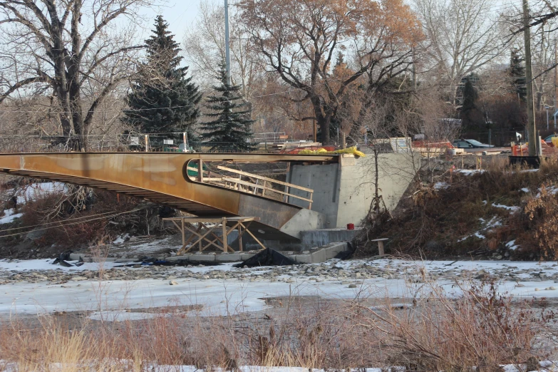 a bridge being built on the side of a river